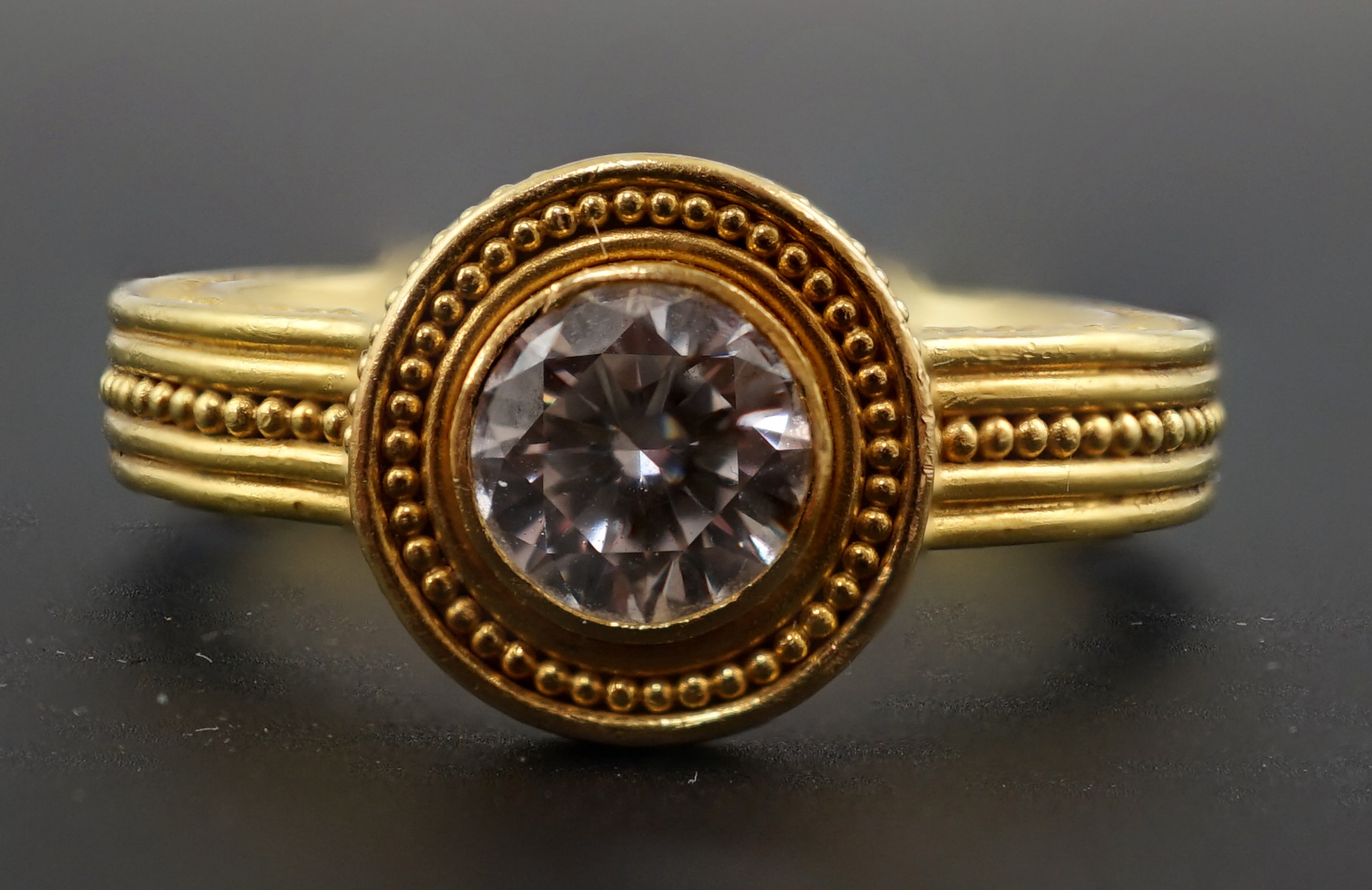 A 22k gold and collet set solitaire diamond dress ring